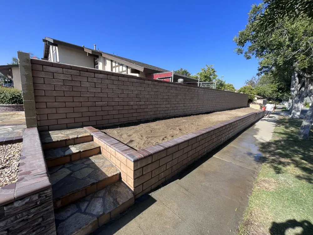 Structural block retaining wall and steps